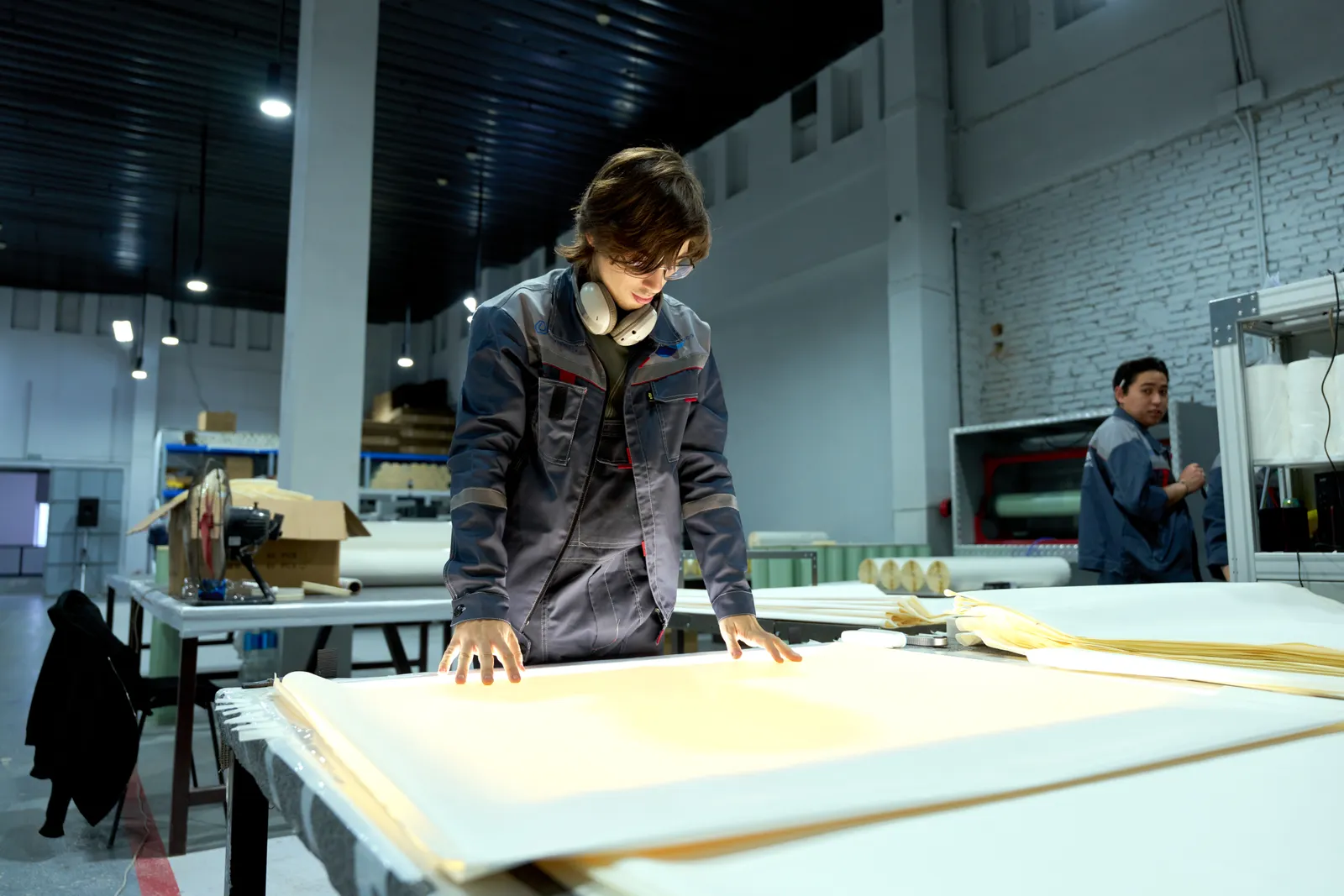 Professional buyer inspecting textile materials inside a manufacturing facility